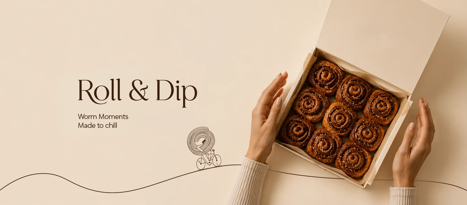 Roll & Dip packaging and cinnamon rolls on a warm cream background